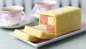 Battenberg Cake, sponge checkered sponge cake spread with apricot preserves and coated with marzipan. It is amazing.
